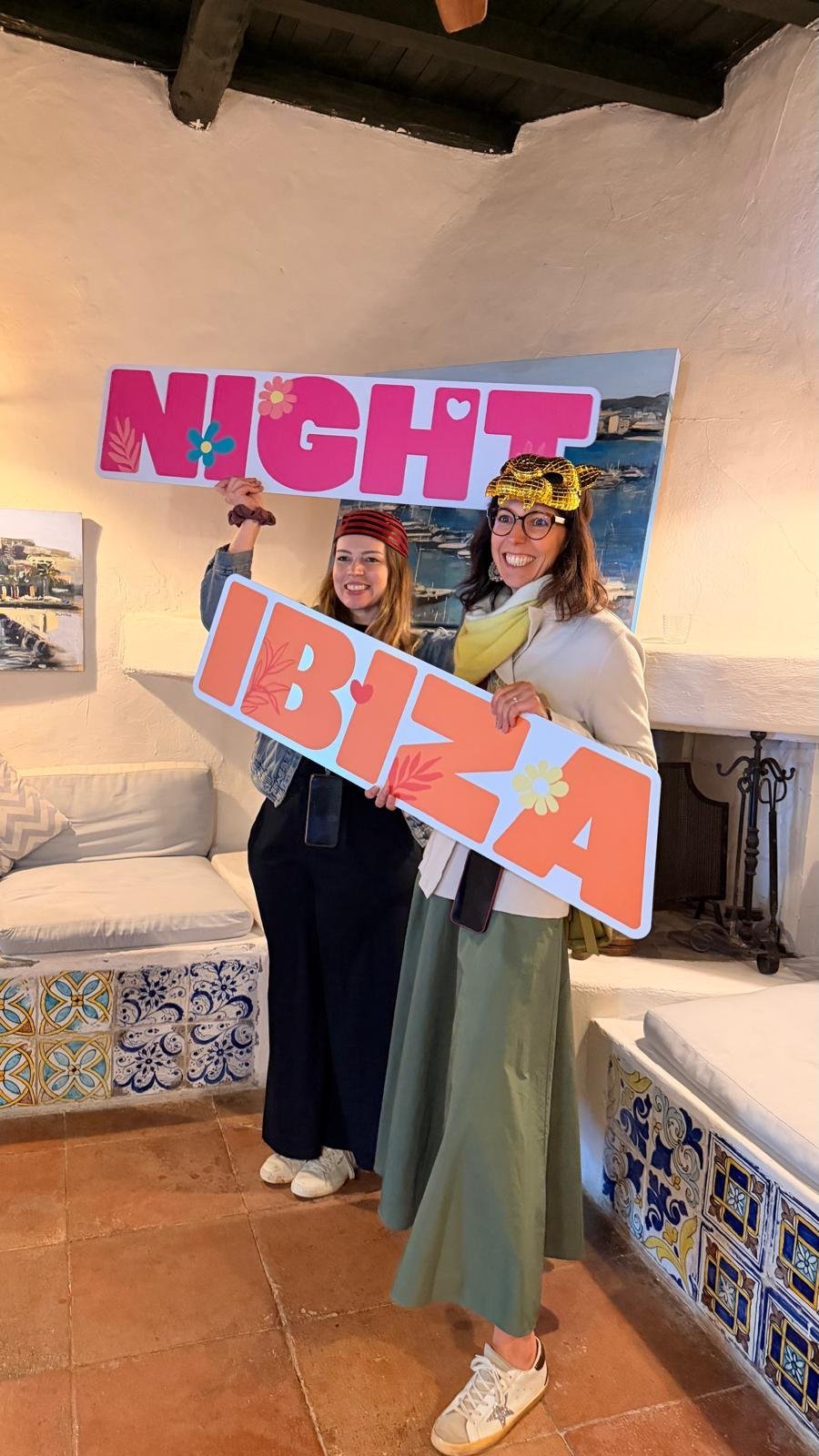 Two wedding guests holding NIGHT IBIZA photo booth props at Casa Colonial Ibiza