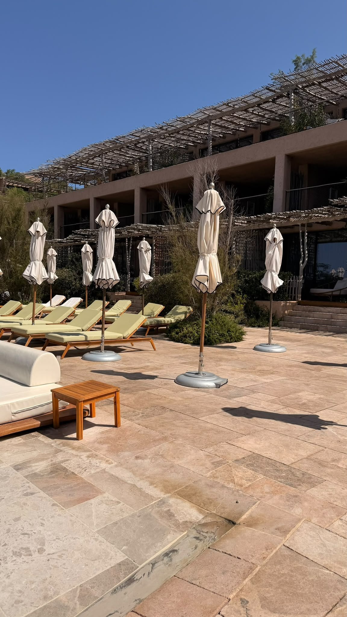 Terrace with parasols and sun loungers at Six Senses Ibiza